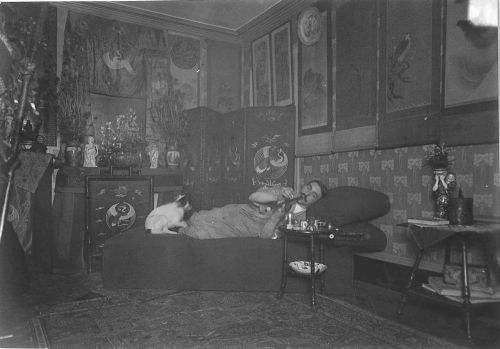 Opium smoker with cat - pets often became addicted to the opium fumes